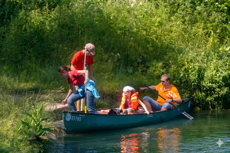 Familie paddelt im Canadier auf der Altmühl mit Schwimmwesten